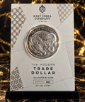 Styled product illustration of Modern Chinese Trade Dollar numbered presentation card on black and gold marble backdrop
