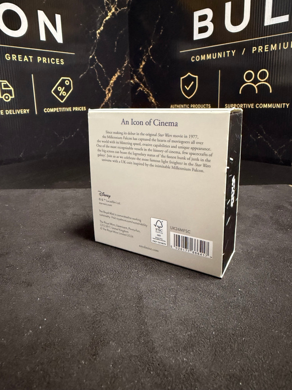 Back of original Royal Mint 2024 Millennium Falcon box showing product code UK24MFSC and visible edge wear